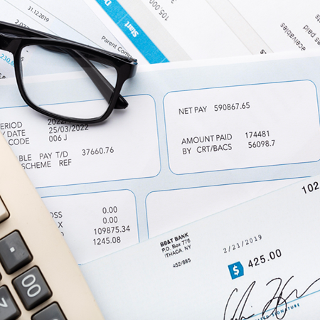 Running payroll with employee pay stubs and tax forms